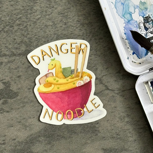 sticker with a red bowl and a yellow snake that looks like ramen. Text says Danger Noodle